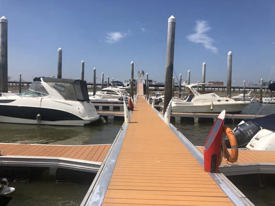 Wooden-deck marina pier with moored boats at an operator site